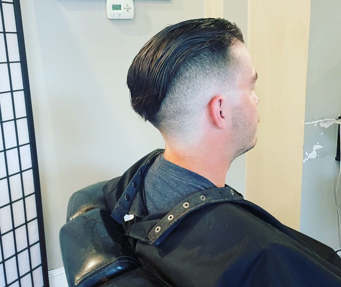 Skin fade with a slicked-back top, cut at LoGrasso's